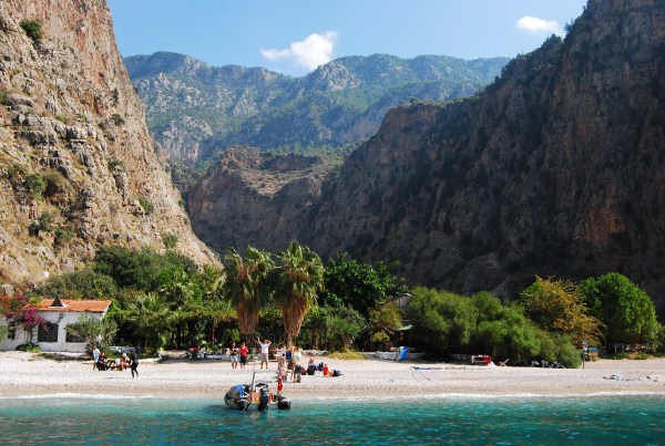 Beach at Butterfly Valley in the day, boats moored up
