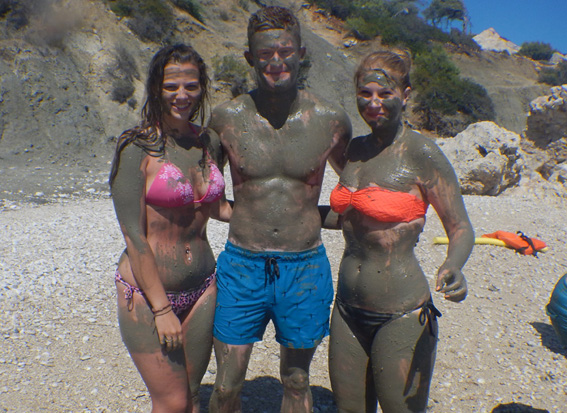 Three people covered in mud