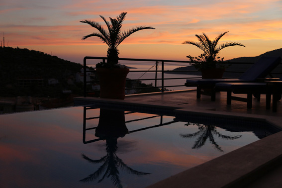 Infinity pool and terrace with Kalamar Bay beyond